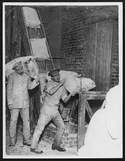 In the Bakery - putting sacks of flour on the elevator