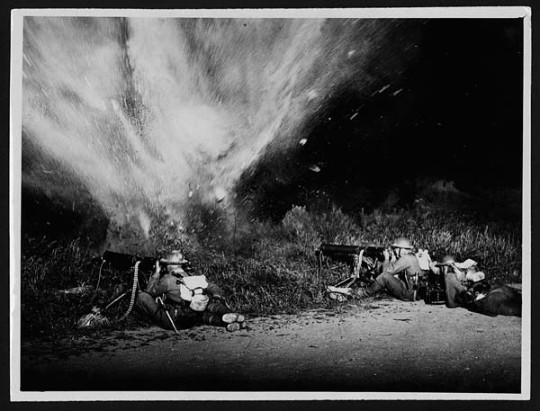 Machine gunners firing during which a mine explodes