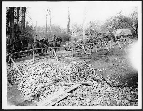 Transport going over a wooden road built round a mine crater