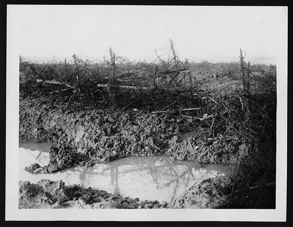 (13) C.1046 - German barbed wire and shell holes - after rain