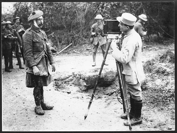 (82) D.551 - French official kinematographer taking a close picture of one of our wounded