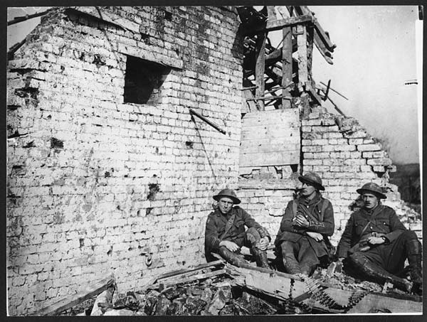 (19) D.1044 - Officers resting in corner on wrecked building