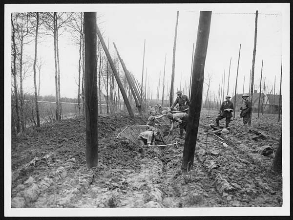 (112) L.668 - Troops digging trenches in a hop field