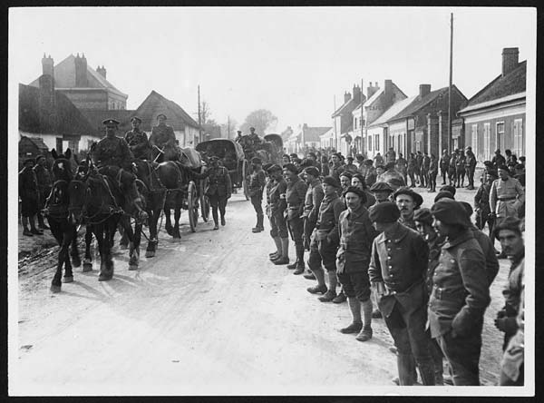 (33) N.430 - French troops lined up watching British Artillery passing through a village