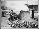 L.543Empty tins being placed in a kiln to extract the solder from them
