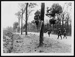 N.374Stretcher bearers moving hurriedly along a shell shattered road in the fighting area