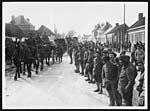 N.430French troops lined up watching British Artillery passing through a village