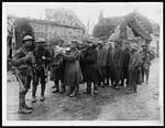 X.33091German prisoners, some of whom are carrying wounded comrade