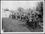 X.34090Cyclists resting in a captured village
